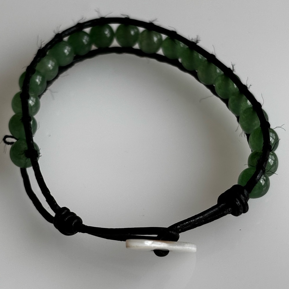 Green beaded bracelet /black cord/ button & hole closure/first wrist size 6.5 in